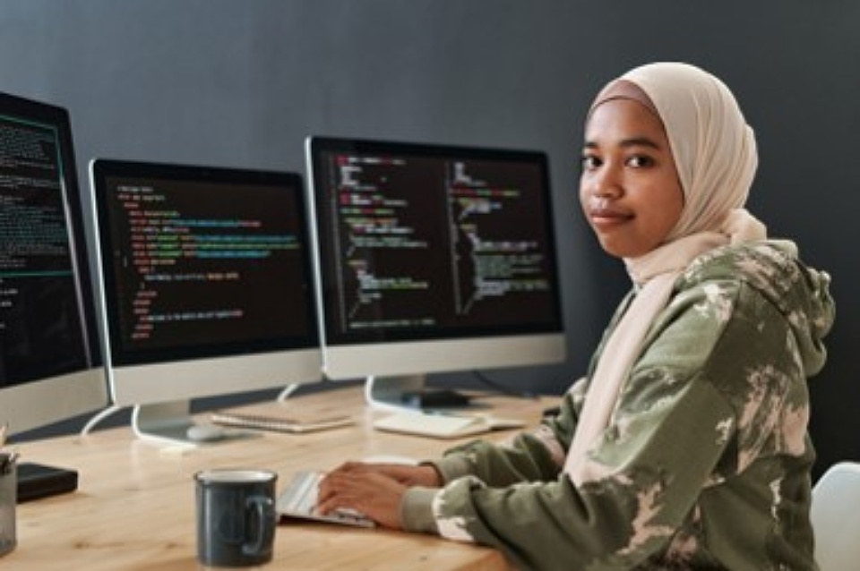 Woman working on a computer in tech IT role